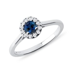Halo prsten s modrým safírem a brilianty v bílém zlatě KLENOTA